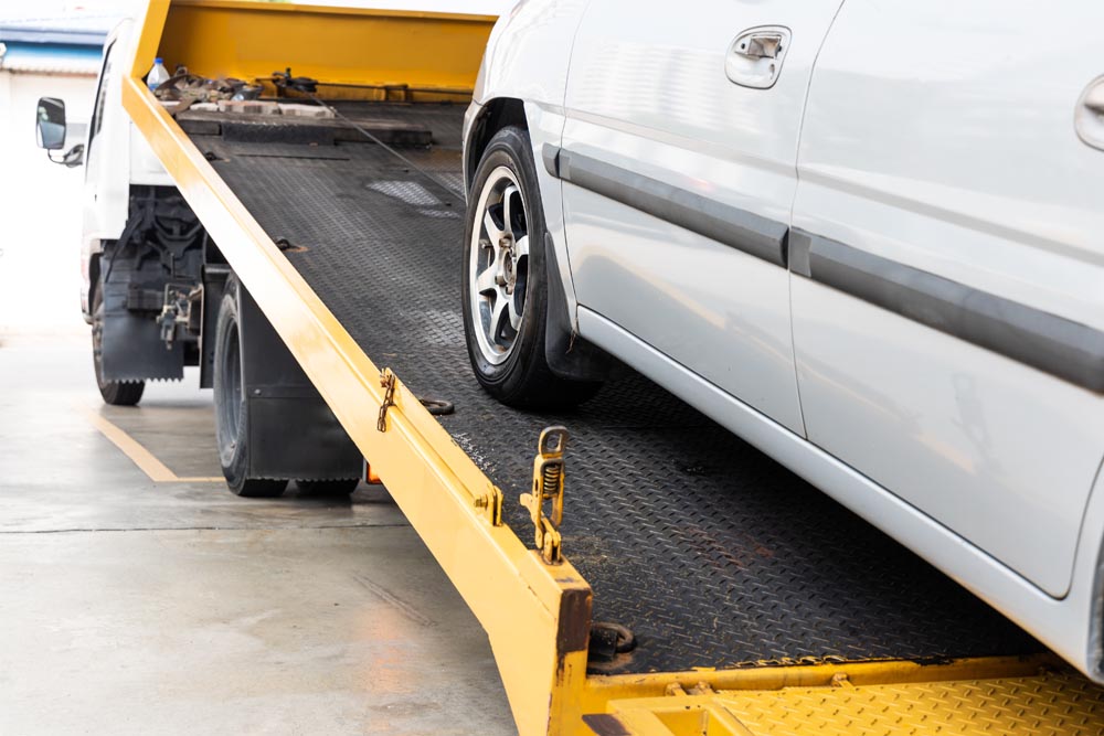 car being towed onto flatbed